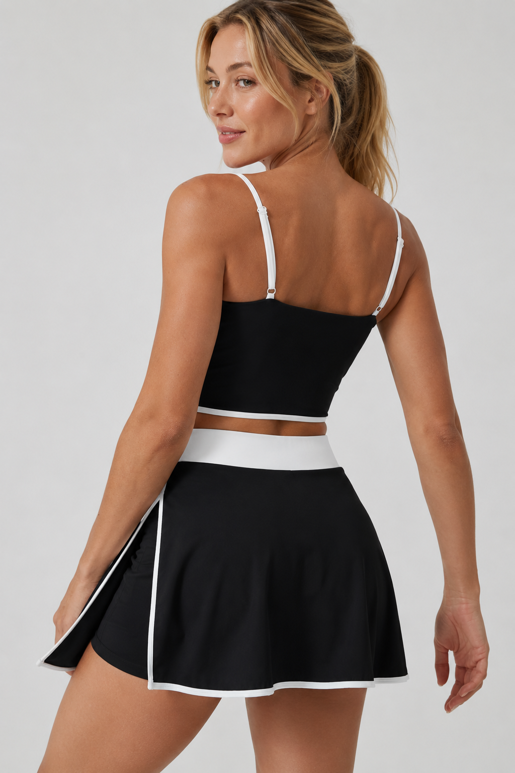 Lila Zen Women's color-blocked two-piece workout outfit, including a tennis skirt and a backless bra